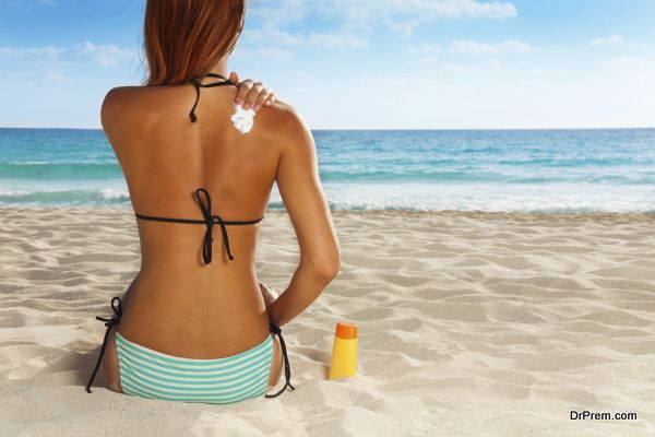 Ð¡ute girl's back with sunscreen on it